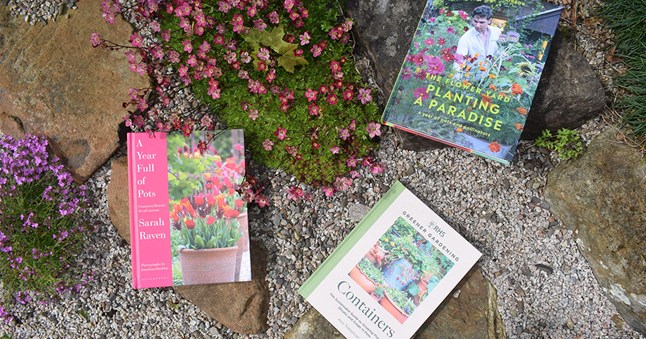 Gardening books spread out in a rock garden