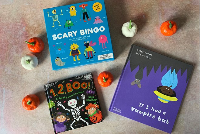 Halloween-themed books surrounded by pumpkins