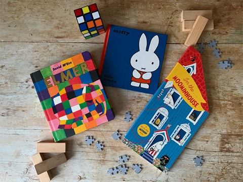 Children's books scattered on rustic background